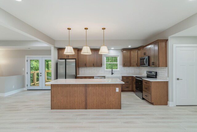 826 Long Mill Rd, Athens, TN 37303 - kitchen with stainless steel appliances, a kitchen island, light countertops, decorative backsplash, and decorative light fixtures