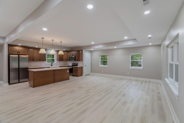 826 Long Mill Rd, Athens, TN 37303 - kitchen featuring stainless steel appliances, open floor plan, backsplash, a center island, and light countertops