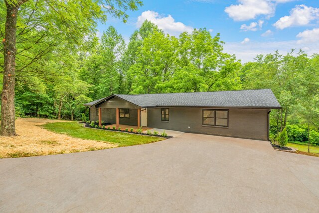 826 Long Mill Rd, Athens, TN 37303 - view of front of home with driveway, covered porch, brick siding, and a view of trees