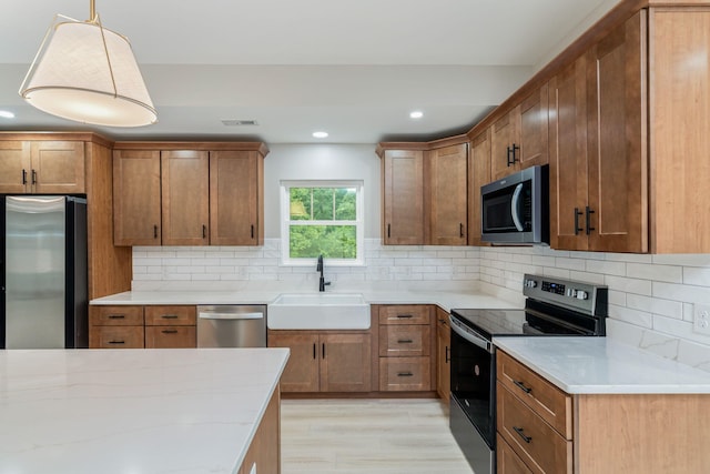 826 Long Mill Rd, Athens, TN 37303 - kitchen featuring appliances with stainless steel finishes, a sink, brown cabinetry, and recessed lighting