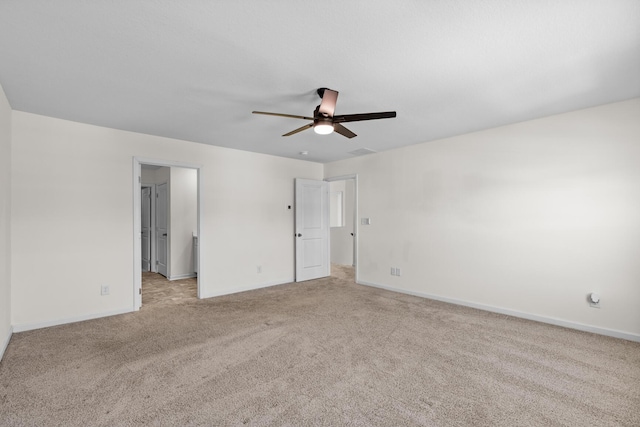 spare room featuring ceiling fan and light colored carpet