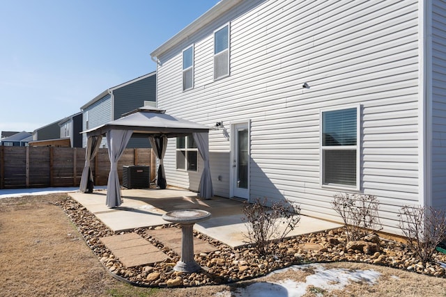 rear view of house featuring a gazebo, central AC, and a patio