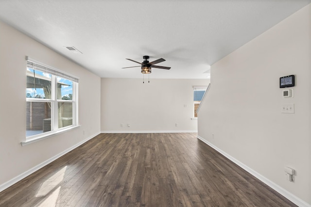 spare room with ceiling fan and dark wood-type flooring