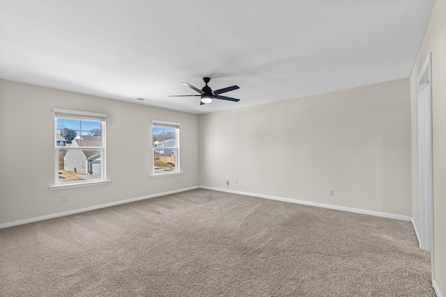 empty room featuring carpet floors and ceiling fan