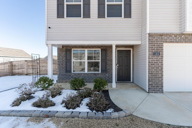 view of snow covered property entrance