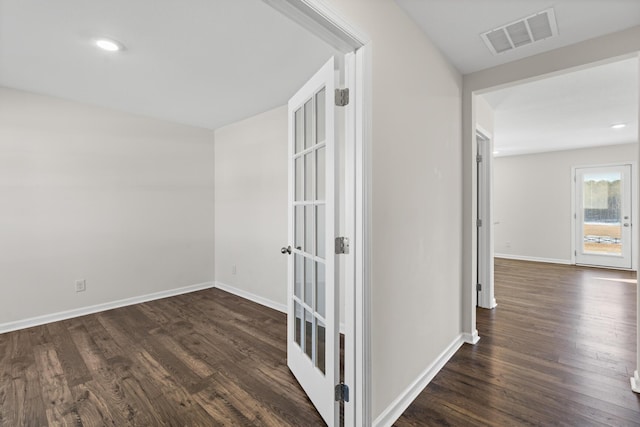 corridor with french doors and dark hardwood / wood-style flooring