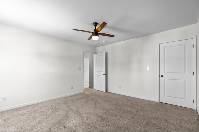 empty room with ceiling fan and carpet