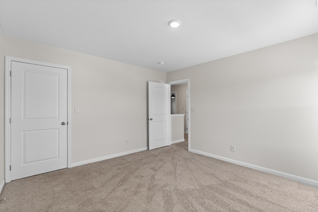 spare room featuring light colored carpet