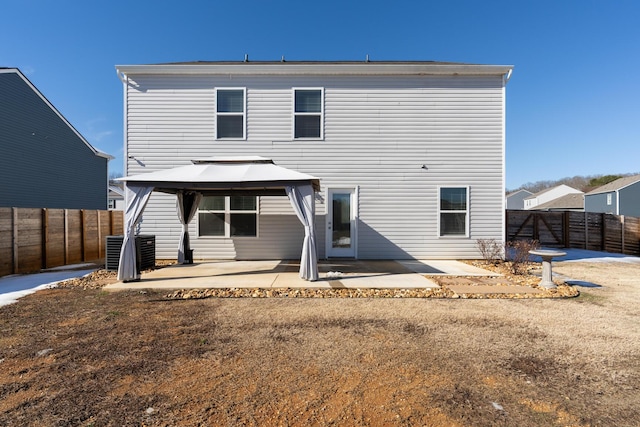 back of property featuring a yard, a patio area, and a gazebo