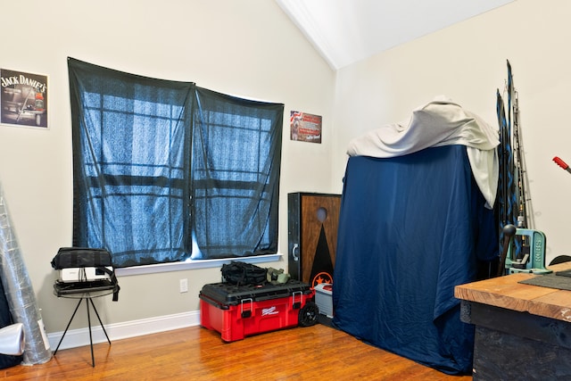 interior space with hardwood / wood-style floors and lofted ceiling