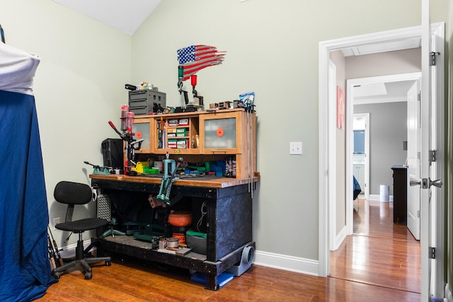 office area featuring hardwood / wood-style floors and vaulted ceiling