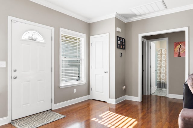 foyer with dark hardwood / wood-style flooring and crown molding