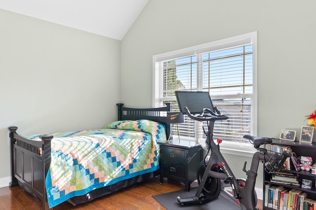 bedroom featuring dark hardwood / wood-style flooring and lofted ceiling