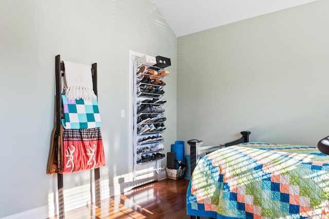 bedroom featuring dark hardwood / wood-style flooring and vaulted ceiling