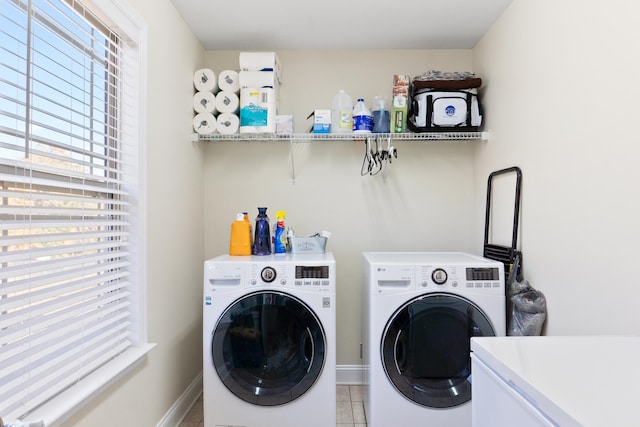 clothes washing area featuring separate washer and dryer and light tile patterned flooring