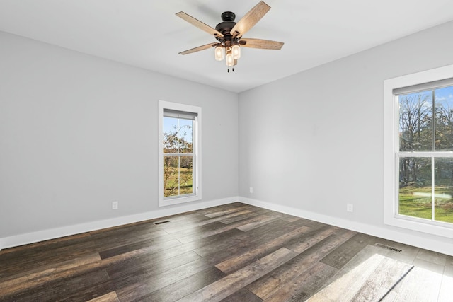 spare room with dark hardwood / wood-style floors and ceiling fan