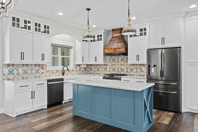 kitchen featuring hanging light fixtures, dark hardwood / wood-style flooring, premium range hood, and appliances with stainless steel finishes