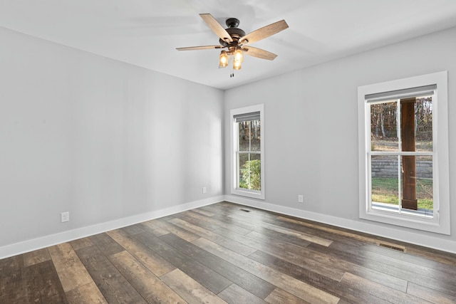 empty room with dark hardwood / wood-style floors and ceiling fan