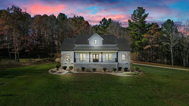 view of front of home featuring a porch and a yard