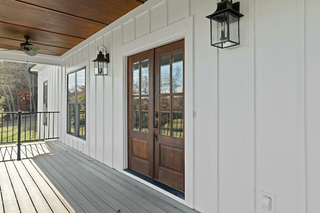 entrance to property with ceiling fan, french doors, and covered porch