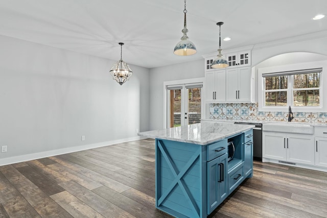 kitchen with pendant lighting, dark hardwood / wood-style floors, and white cabinetry