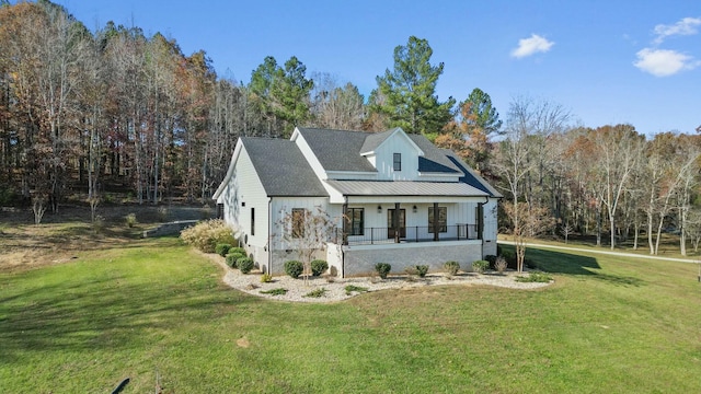 view of side of property featuring a porch and a lawn