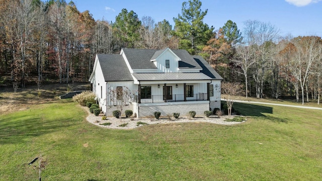 view of front facade with covered porch and a front yard