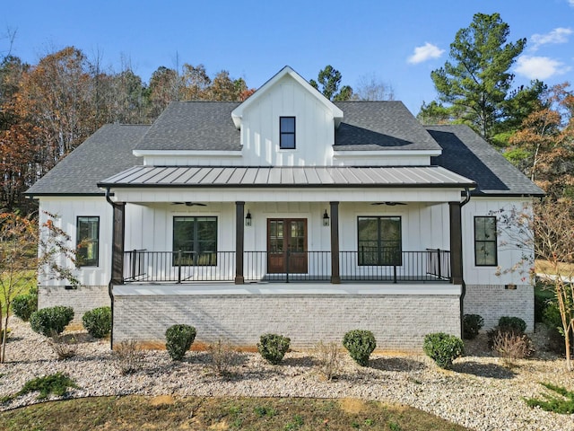 modern farmhouse style home with ceiling fan, french doors, and covered porch