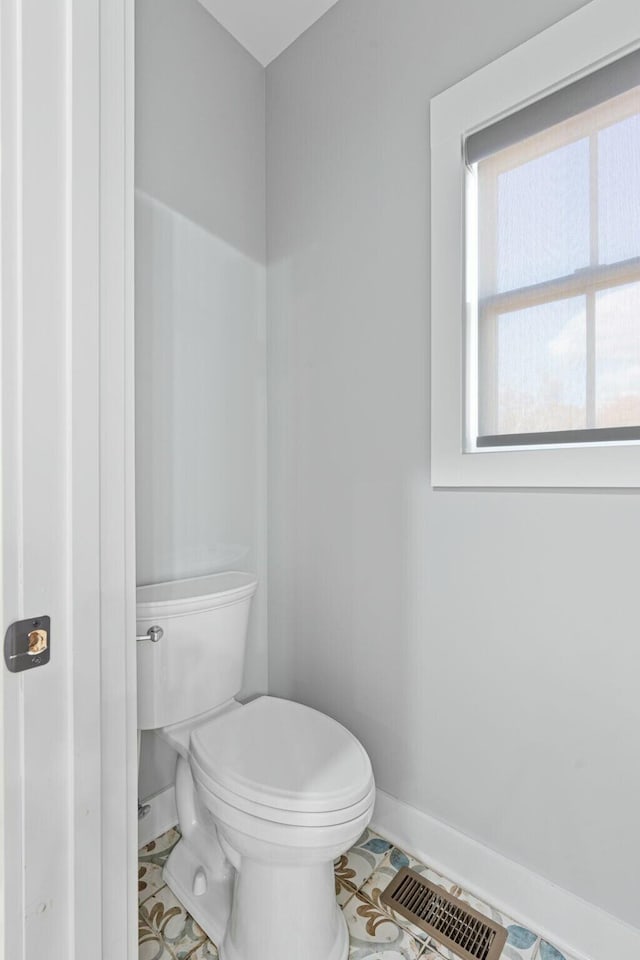 bathroom with tile patterned flooring and toilet