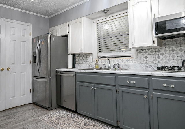 kitchen featuring white cabinets, sink, gray cabinetry, and stainless steel appliances