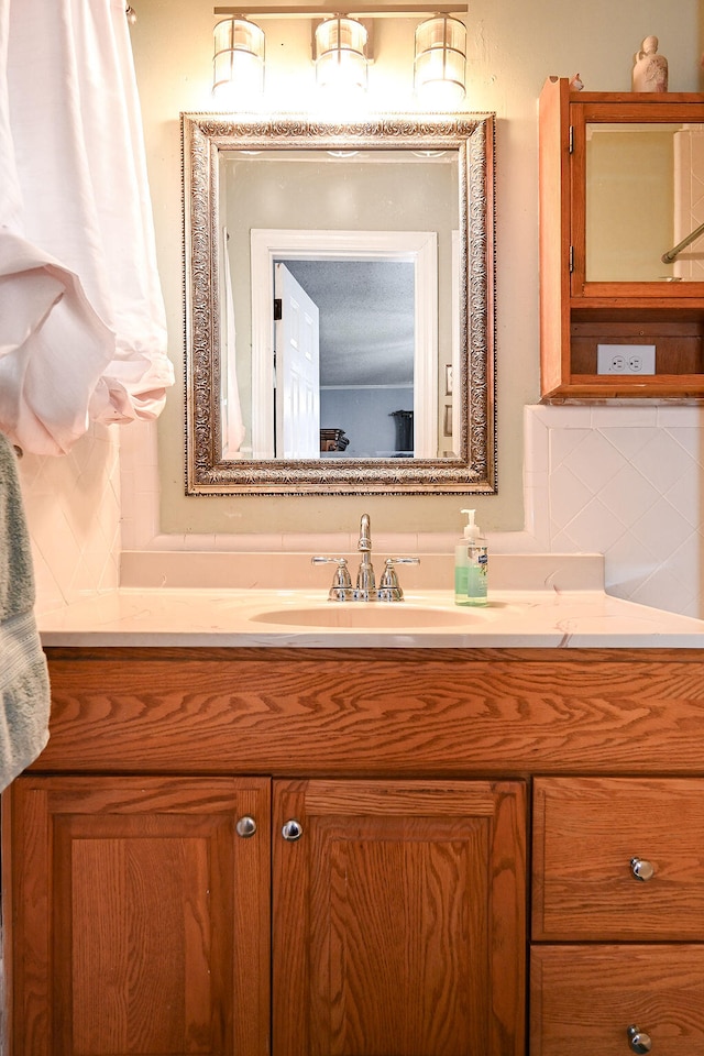 bathroom with decorative backsplash and vanity