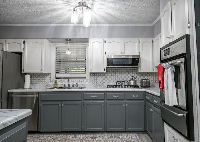 kitchen featuring gray cabinetry, white cabinetry, sink, and appliances with stainless steel finishes