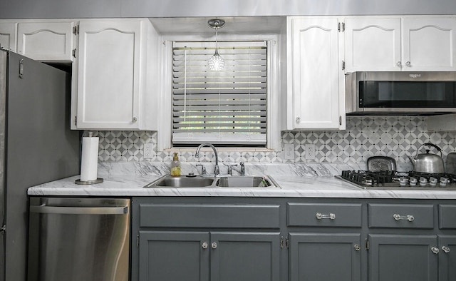 kitchen with white cabinetry, sink, and appliances with stainless steel finishes