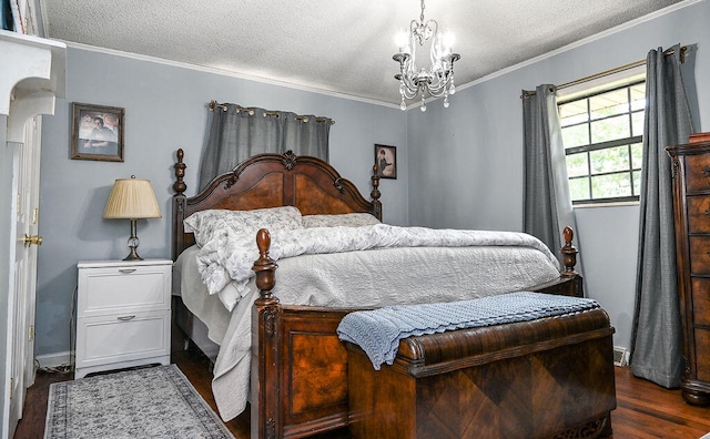 bedroom with a textured ceiling, crown molding, dark wood-type flooring, and a chandelier