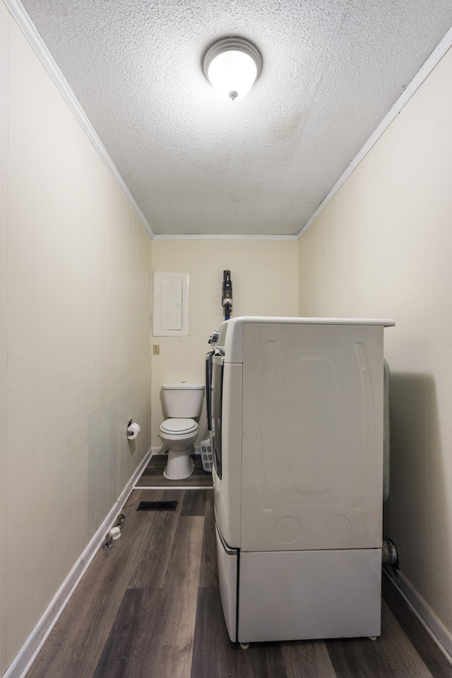 clothes washing area with washer / dryer, dark hardwood / wood-style flooring, a textured ceiling, and crown molding