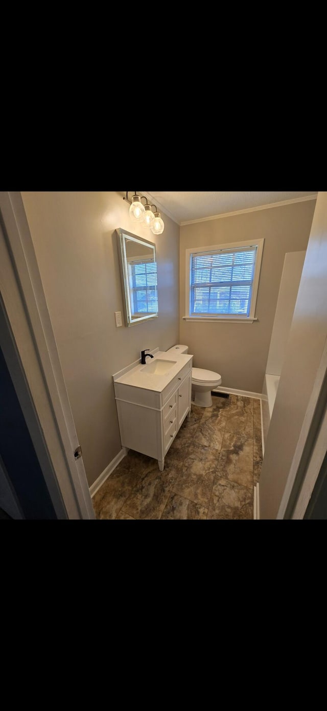 bathroom with vanity, toilet, ornamental molding, and an inviting chandelier