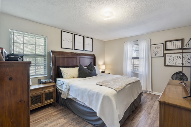 bedroom with wood-type flooring and a textured ceiling