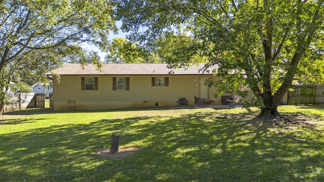 rear view of house with a yard