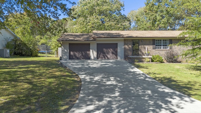 view of front facade with a garage, a front yard, and a trampoline