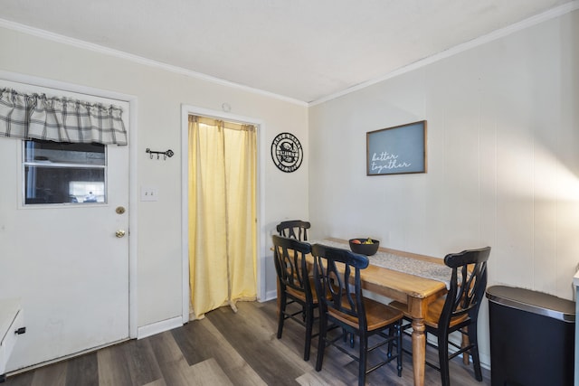 dining area featuring dark hardwood / wood-style floors and ornamental molding