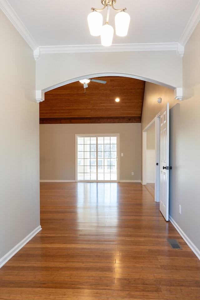 unfurnished room with a chandelier, crown molding, and wood-type flooring