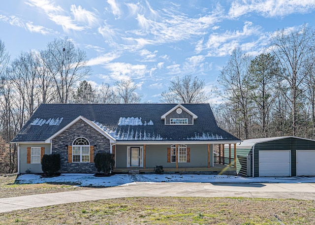 view of front of property featuring a garage, an outbuilding, and a carport