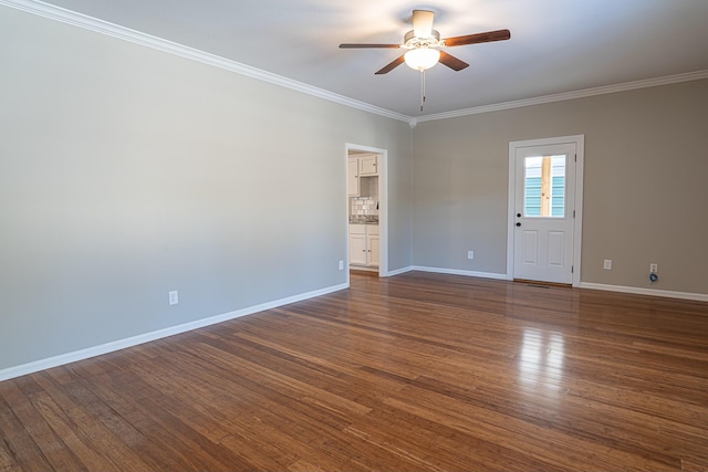 unfurnished room with ceiling fan, dark wood-type flooring, and crown molding