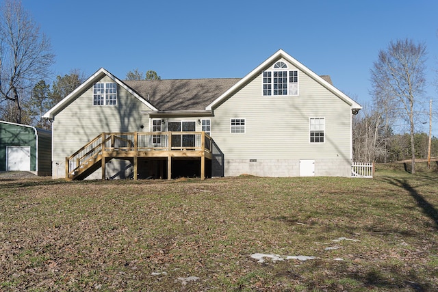 rear view of property with a wooden deck and a yard