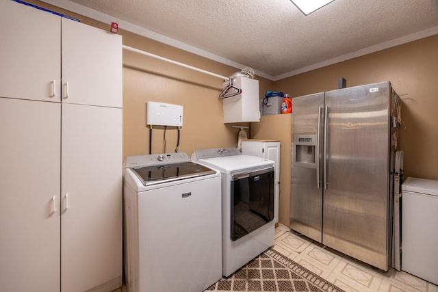 laundry room with a textured ceiling and separate washer and dryer