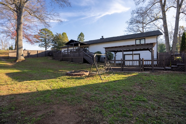 view of yard featuring a pergola, an outdoor fire pit, and a deck