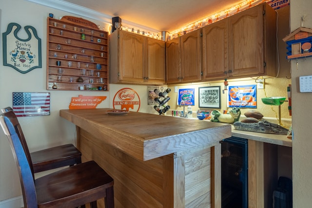 kitchen with a breakfast bar area and wine cooler