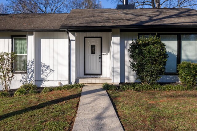 115 Lake Cir, Harriman, TN 37748 - entrance to property with roof with shingles, a lawn, and a chimney