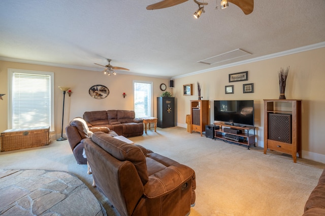 carpeted living room with ceiling fan, a textured ceiling, and ornamental molding