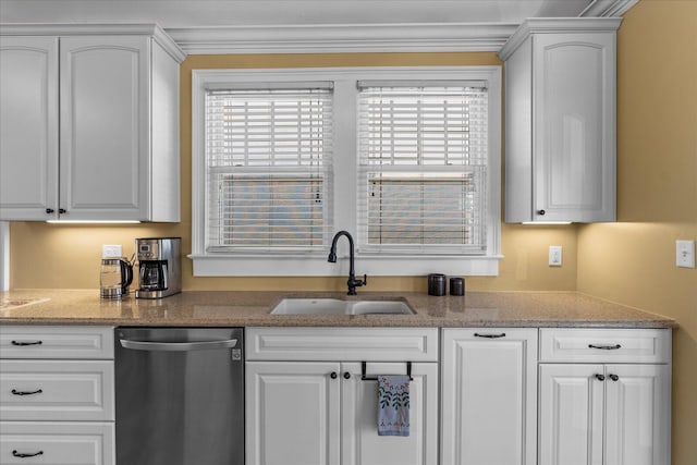 kitchen featuring stainless steel dishwasher, a wealth of natural light, sink, and white cabinets